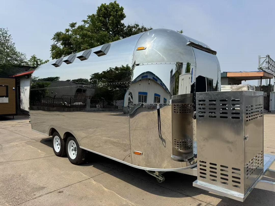 The finished trailer photographed from the side in the workshop yard